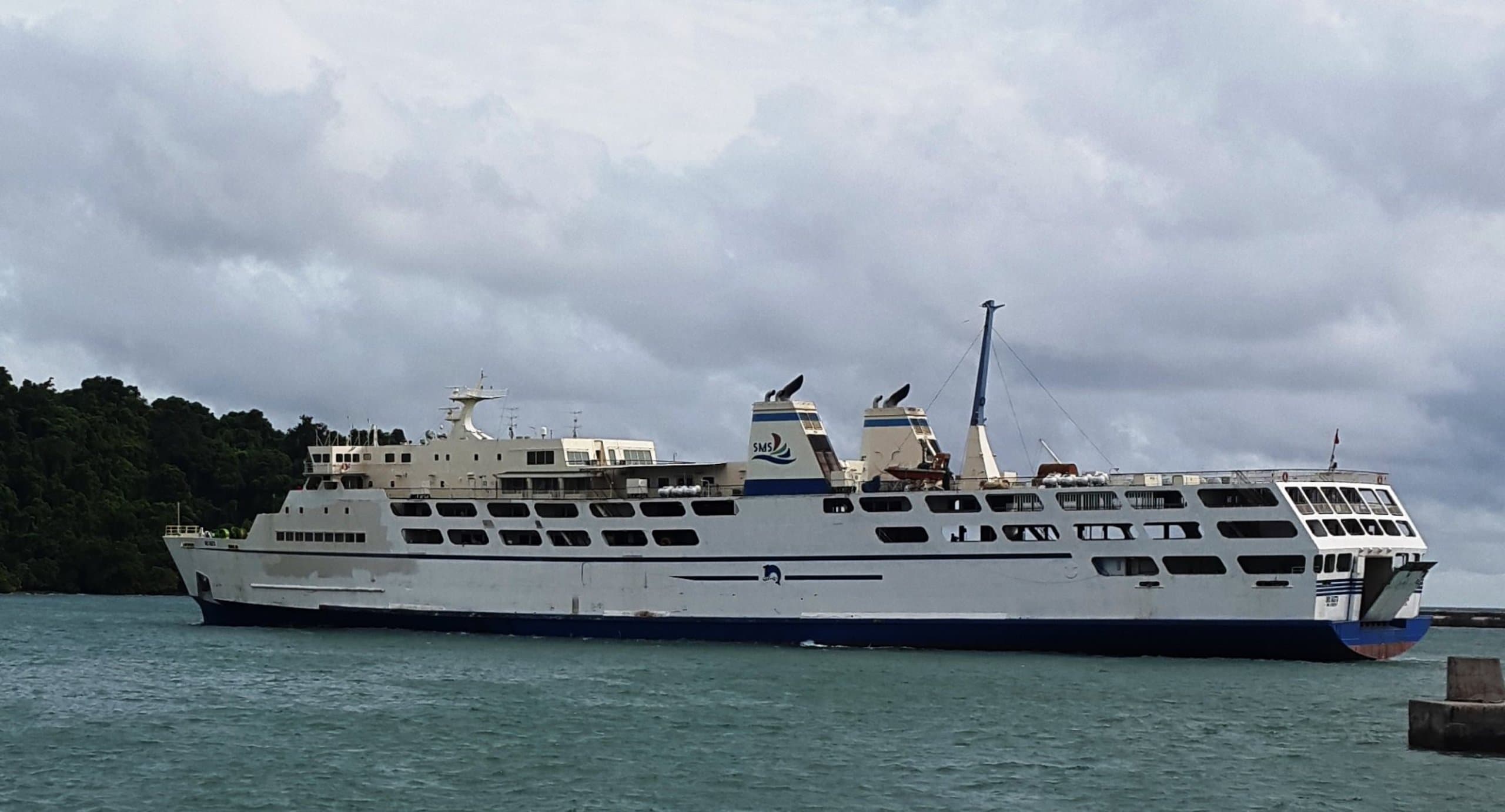 A view of Cilegon's cityscape blending residential areas with distant industrial structures under a daytime sky